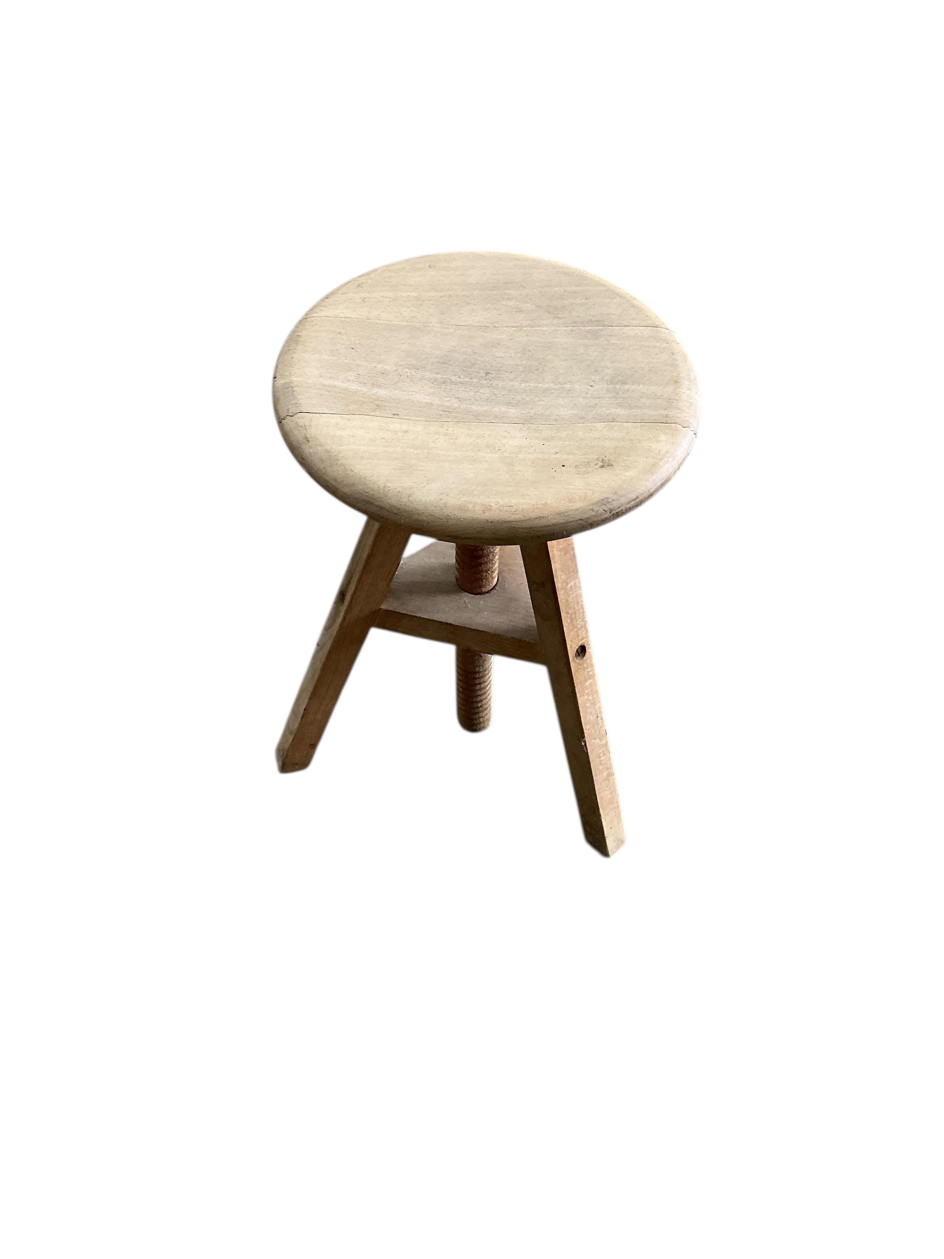 A circular beech revolving adjustable stool